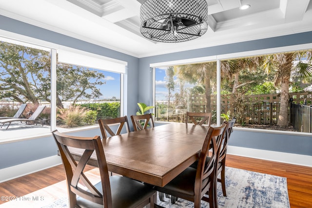 dining room with hardwood / wood-style flooring and crown molding