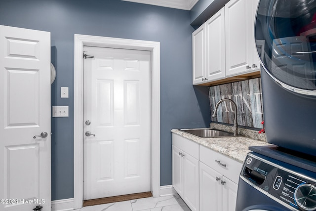 laundry room with sink, cabinets, and ornamental molding