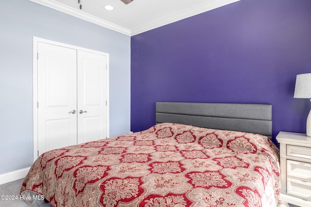 bedroom featuring ornamental molding, carpet floors, and a closet