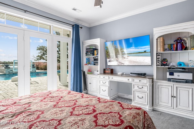 bedroom featuring access to outside, crown molding, ceiling fan, built in desk, and light colored carpet