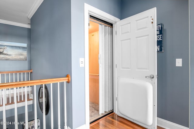 hall with crown molding and hardwood / wood-style floors