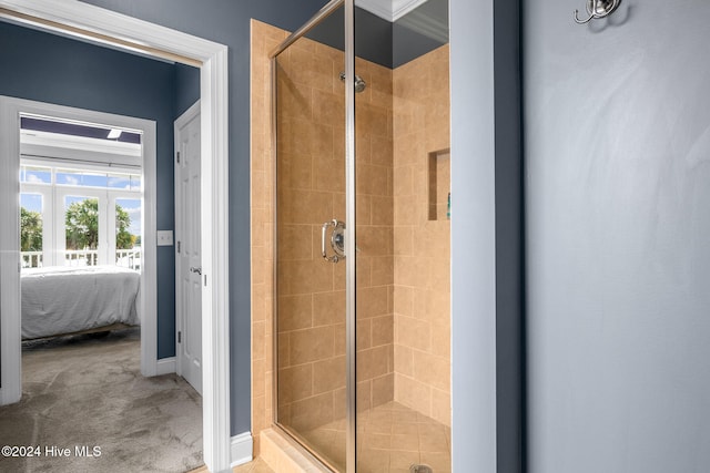 bathroom with crown molding and an enclosed shower