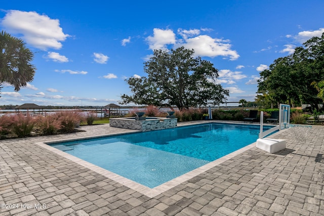 view of swimming pool with a patio