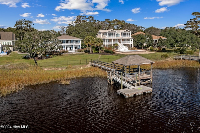 dock area featuring a water view and a yard