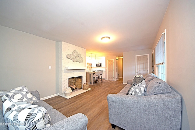 living room with hardwood / wood-style flooring and a fireplace