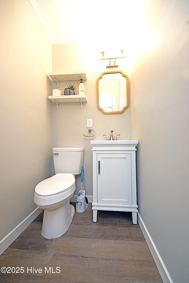 bathroom with vanity, hardwood / wood-style flooring, and toilet