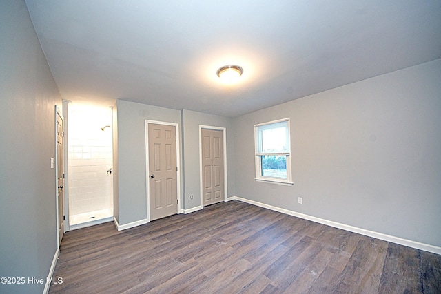 unfurnished bedroom featuring dark hardwood / wood-style floors and a closet