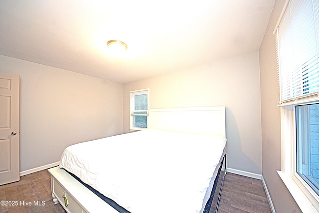 bedroom with dark hardwood / wood-style flooring