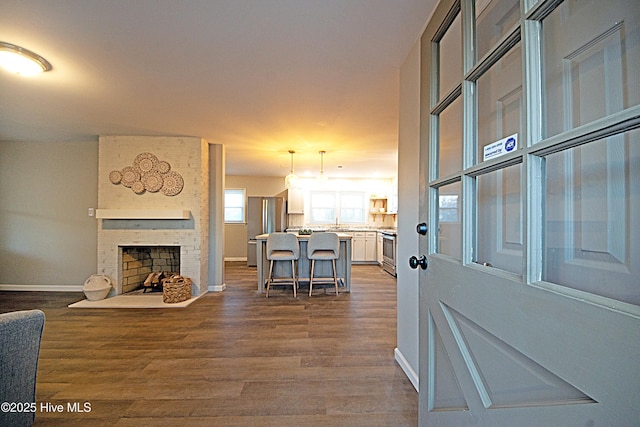 entryway with hardwood / wood-style flooring and a fireplace