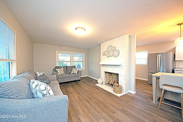 living room with dark hardwood / wood-style floors and a fireplace