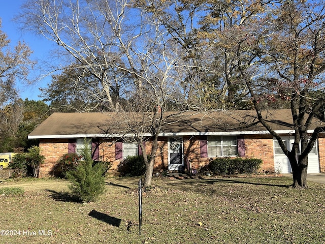 ranch-style home with a front lawn