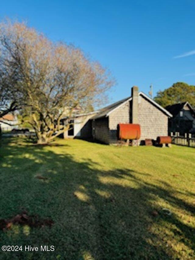 view of home's exterior with a yard