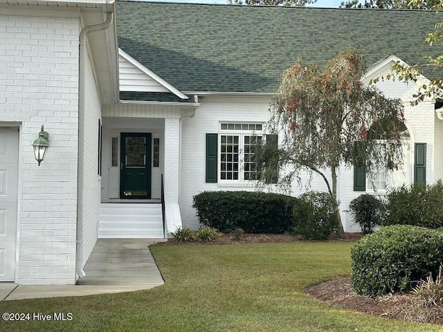 109 St Gallen Ct, New Bern, NC 28562 - property entrance with brick siding, a lawn, and roof with shingles