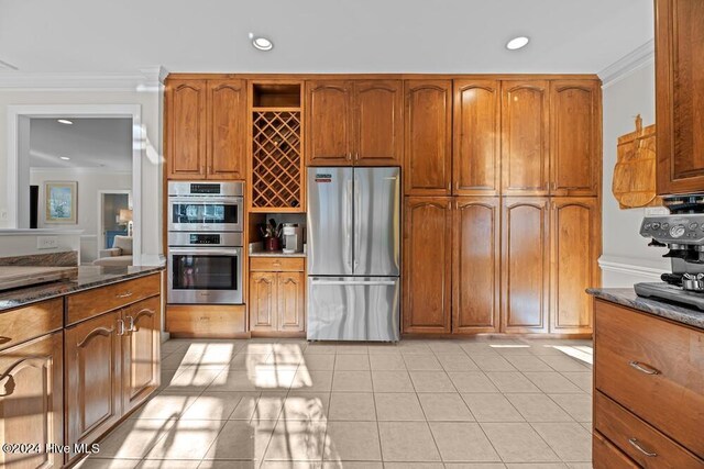 109 St Gallen Ct, New Bern, NC 28562 - kitchen with stainless steel appliances, recessed lighting, ornamental molding, brown cabinetry, and dark stone counters