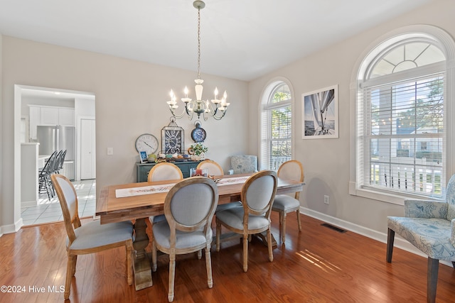 dining area featuring an inviting chandelier and light hardwood / wood-style flooring