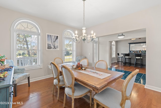 dining space with a chandelier, plenty of natural light, and hardwood / wood-style floors