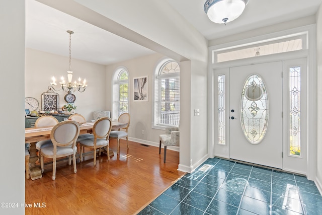 foyer with a chandelier and dark wood-type flooring