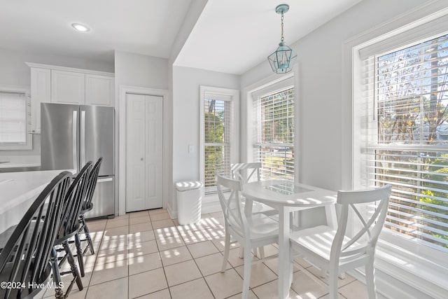 dining room with a wealth of natural light and light tile patterned flooring