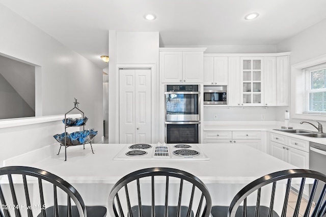 kitchen with white cabinets, sink, and appliances with stainless steel finishes