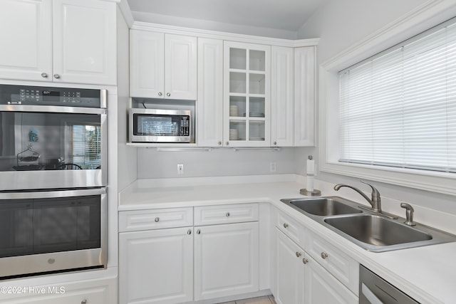 kitchen featuring white cabinets, sink, and appliances with stainless steel finishes