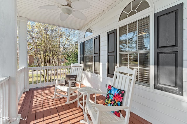 deck featuring covered porch and ceiling fan