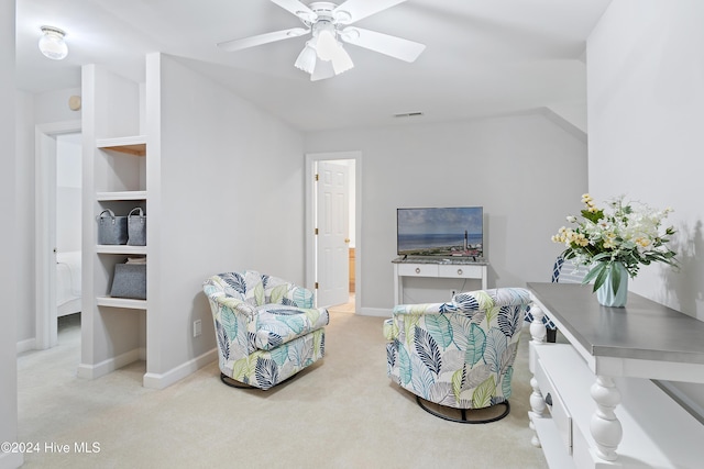 sitting room featuring carpet and ceiling fan