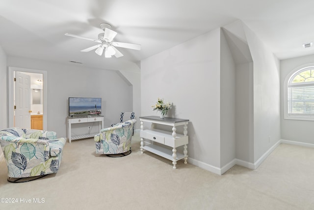 living area with ceiling fan and light carpet