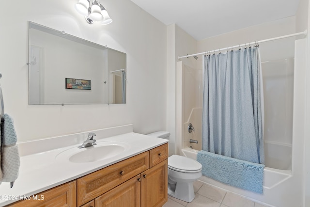 full bathroom featuring toilet, shower / bath combo, vanity, and tile patterned floors