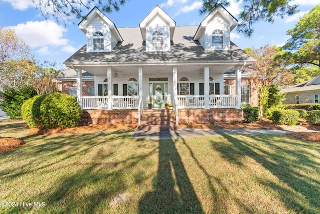 new england style home with a front lawn and covered porch