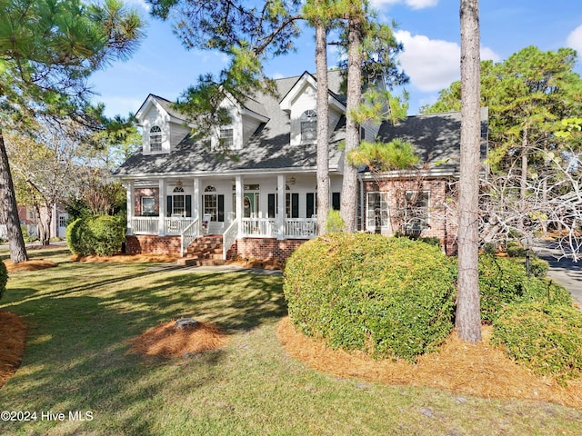 back of property featuring a lawn and a porch