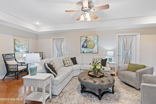 living room with hardwood / wood-style floors and ceiling fan