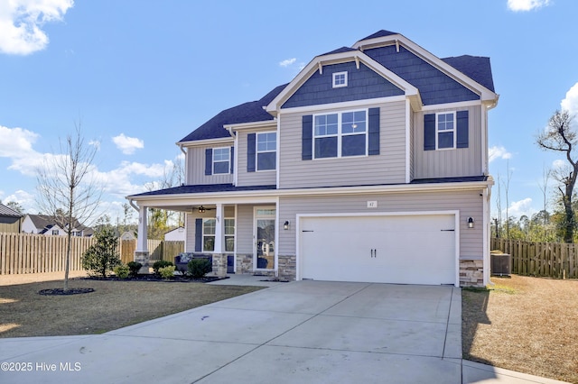 craftsman house with a front yard and a garage