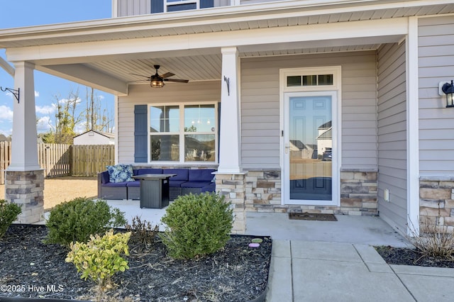 view of exterior entry featuring outdoor lounge area, a porch, and ceiling fan