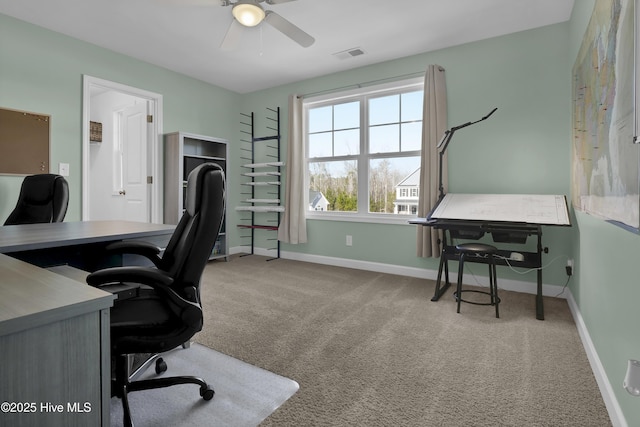 home office featuring light carpet and ceiling fan