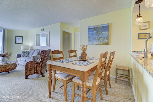 2000 New River Inlet Rd Unit 1203, North Topsail Beach, NC 28460 - dining room featuring light colored carpet, plenty of natural light, and a textured ceiling