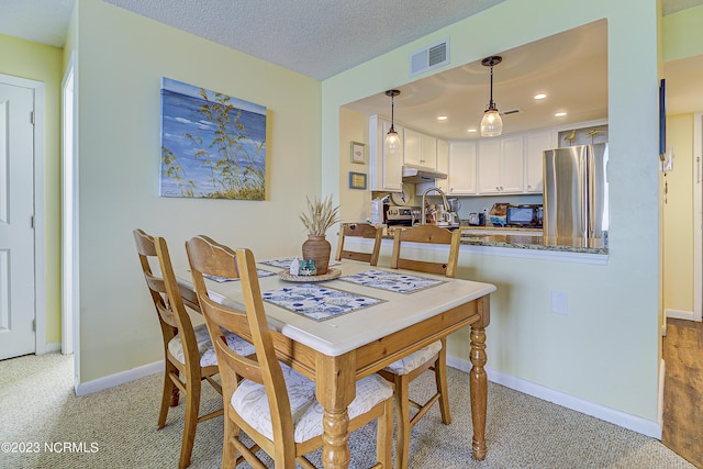 2000 New River Inlet Rd Unit 1203, North Topsail Beach, NC 28460 - dining area with light colored carpet, recessed lighting, and baseboards