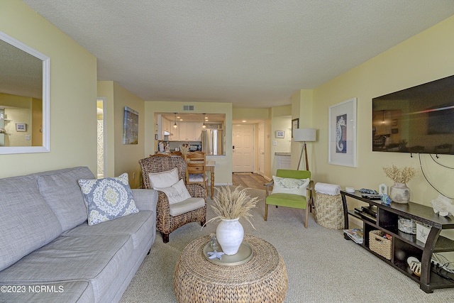 2000 New River Inlet Rd Unit 1203, North Topsail Beach, NC 28460 - carpeted living room with a textured ceiling