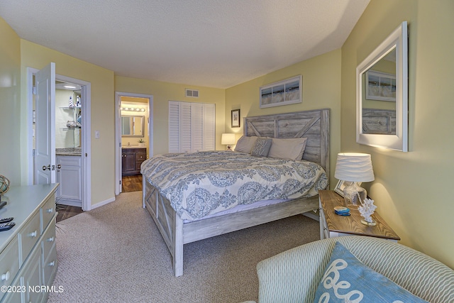2000 New River Inlet Rd Unit 1203, North Topsail Beach, NC 28460 - carpeted bedroom with ensuite bathroom