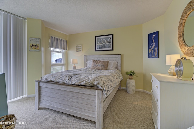 2000 New River Inlet Rd Unit 1203, North Topsail Beach, NC 28460 - bedroom featuring light carpet, baseboards, and a textured ceiling