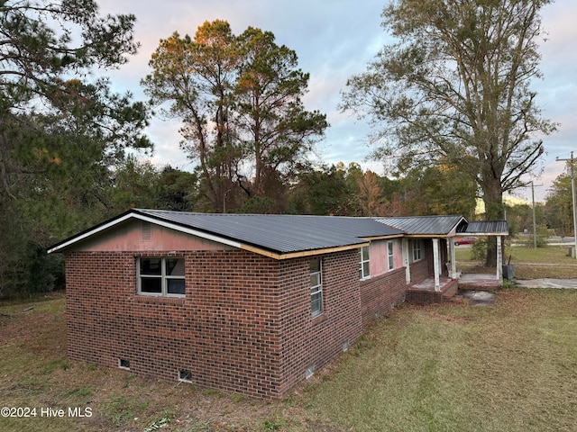 view of side of property with a lawn