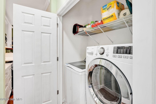 washroom with washer and dryer