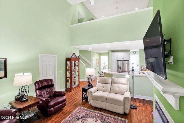 living room featuring high vaulted ceiling and hardwood / wood-style flooring