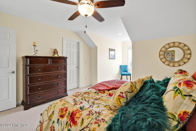 carpeted bedroom with ceiling fan and vaulted ceiling