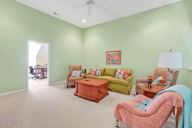 carpeted living room with ceiling fan