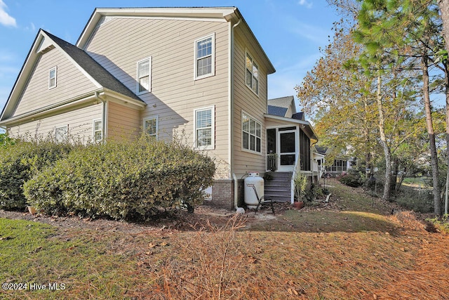 view of home's exterior with a sunroom