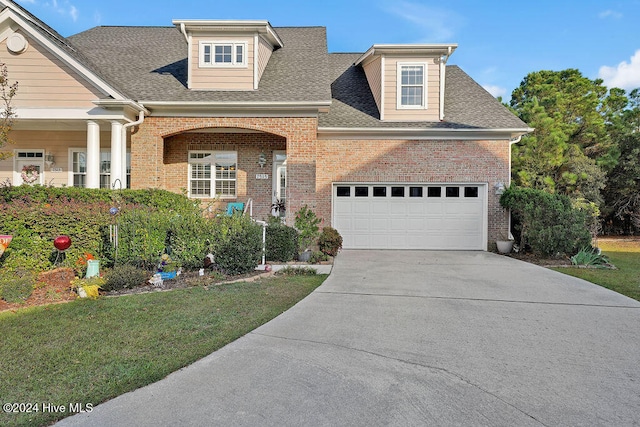 view of front facade featuring a front yard and a garage