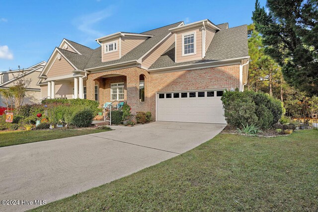 view of front of house featuring a garage and a front lawn