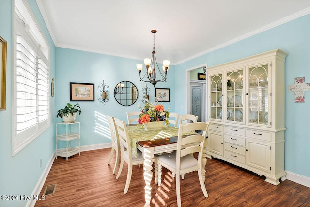 dining space with a notable chandelier, dark hardwood / wood-style floors, and ornamental molding