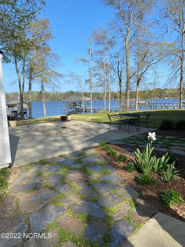 surrounding community with a lawn and a water view