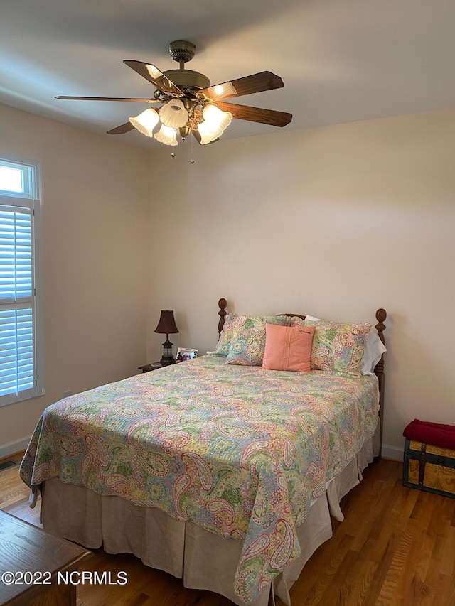 bedroom with hardwood / wood-style flooring and ceiling fan